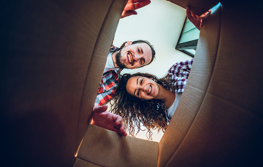 People looking into a carboard box