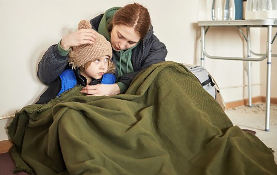 Parent and child under a blanket.